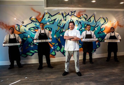 Pasta Armellino staff and chef standing in front of graffiti wall